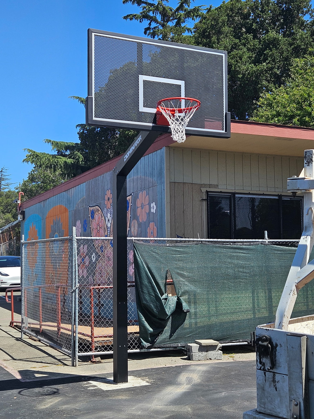 Dominator 72 inch fixed height hoop installed at a school, direct buried with no base plate or bolts in the ground