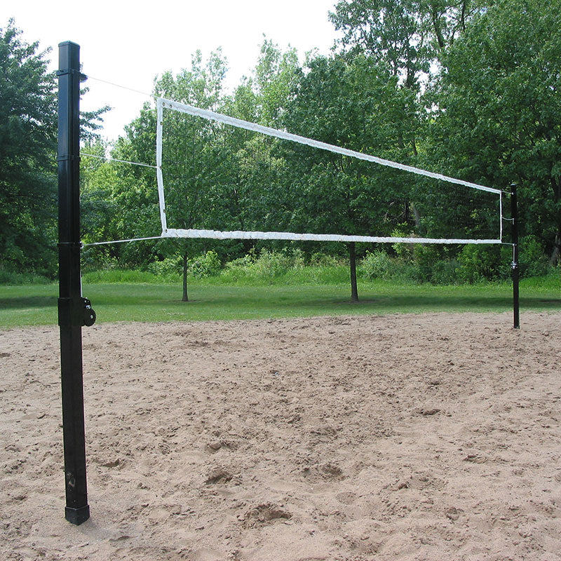 Representative photo: outdoor volleyball net on square steel poles over a sand court
