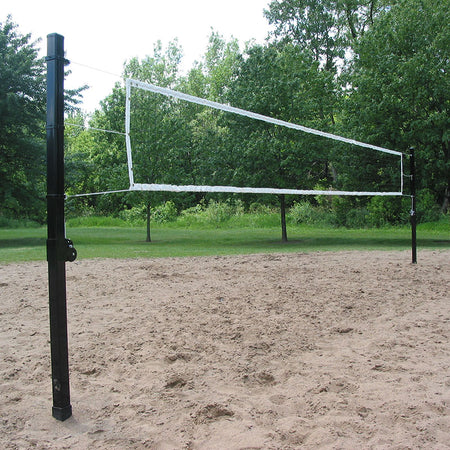 Representative photo: outdoor volleyball net on square steel poles over a sand court
