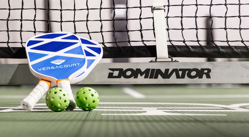 VersaCourt pickleball paddle with pickleballs at the net