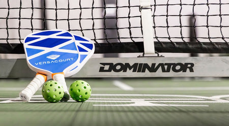 VersaCourt pickleball paddle with pickleballs at the net