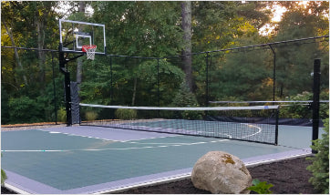 Adjustable net system running from a net pole to the basketball goal post