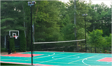 Adjustable net system mounted between court light poles
